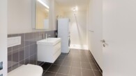 Badezimmer mit Waschturm - 2.5-Zimmer Neubau-Erstbezug am Fusse des Uetlibergs